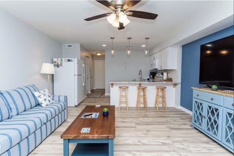 Living room with view into kitchen