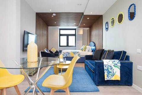 Integrated living, bedroom, and kitchen spaces in an open layout.