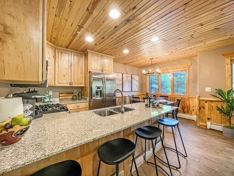 The kitchen is fully stocked and equipped with a stainless steel appliance suite and bar seating for 4.