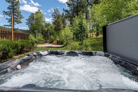The hot tub is strategically placed in a secluded area, providing privacy and tranquility.