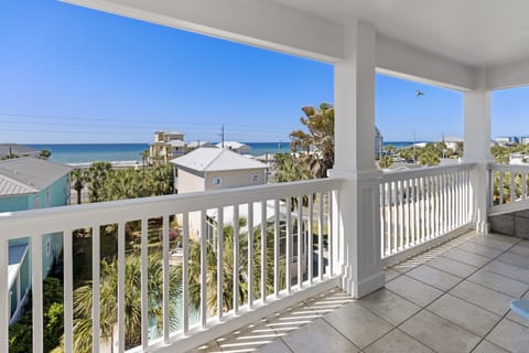 Step onto your private balcony and breathe in the salt air while soaking up stunning ocean views through tropical palms.