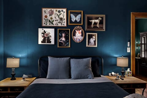 Eclectic wall art lays above you as you lay on your queen bed with bamboo matress topper. Velvet curtains and wood blinds complets the room. Bedroom includes 55" Smart T.V., desk fan, sound machine and charging ports on each night stand. 