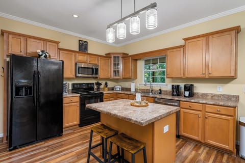 Fully equipped kitchen with sliding doors offer direct access to screen porch.