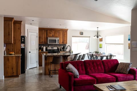 view of main room with kitchen, couch, and dining area. House is 1,400 square feet.