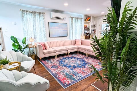 The beautiful living room is luxuriously decorated, embracing 1920s charm and coastal comfort.
