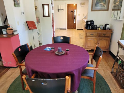 DINING ROOM: The home has a lovely dining room with a dining table, seating for 6 adults, and a wine bar.