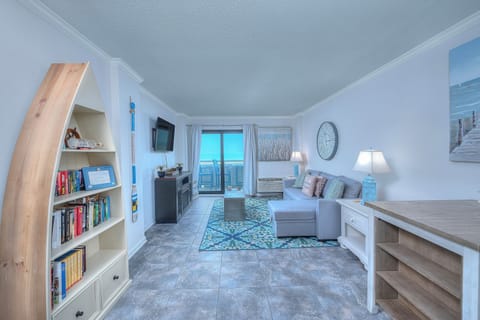 Cuddle up for a late-night movie in this oceanfront living room.