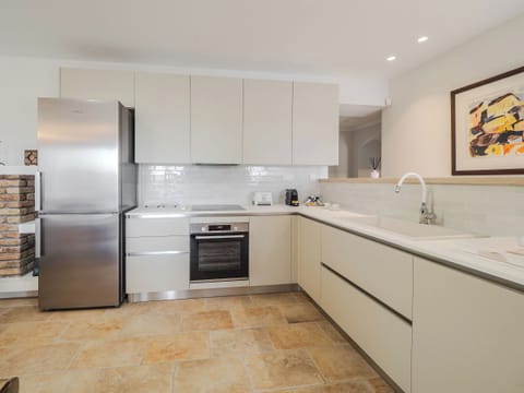 "Enjoy the convenience of home-cooked meals in our stylish kitchen, designed to inspire your inner gourmet chef."