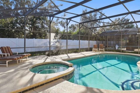 Relax by the private pool and hot tub in a screened enclosure.