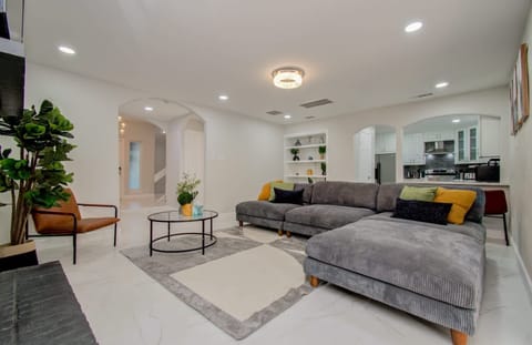 This is a living room unlike any other with its floor-to-ceiling feature fireplace, comfortable plush seating, and bedazzling mirror walls!