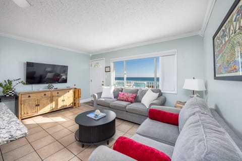 Open concept living area with stylish furnishings, HUGE TV, and balcony access