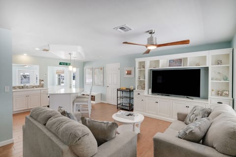 Large open concept living room with ample seating and flat screen TV