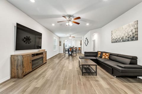 Spacious great room with electric fireplace (heat + color settings) and open dining area—ideal for groups.