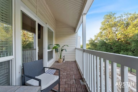 Balcony off of the living room with seating for two and a view of the park