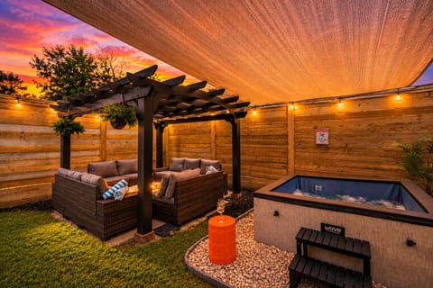 Private hot tub oasis with pergola lounge and glowing sunset ambiance