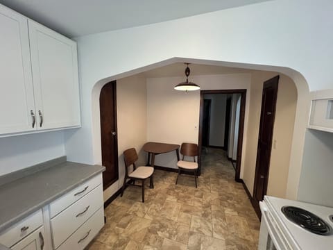 roomy kitchen stocked with pots, pans, utencils, spices, olive oil