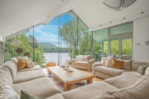 Tanglewood sitting room with glass wall and lake views
