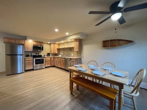 Large dining and kitchen area with stainless steel appliances.
