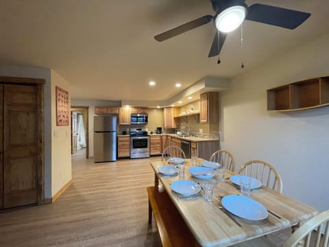 Family style wood table with chairs and a bench. Beautiful dining area, open kitchen floor plan.