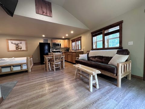 Studio layout with real log wood furniture and cozy fireplace.