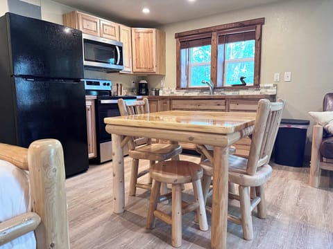 Log wood dining room table, full sized fridge, gas stove, microwave.