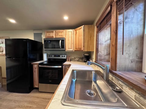 Large stainless steal sink, tiled counter tops, gas stove, full sized fridge.