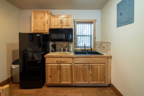 The kitchenette includes a mini fridge, coffee maker, kitchen sink and microwave.