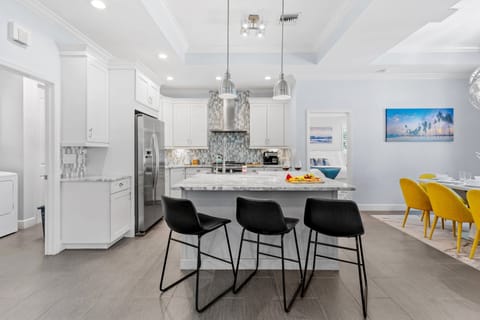 The dining area seamlessly blends with the kitchen and living room