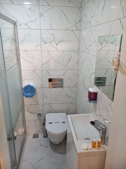 Shower, hair dryer, slippers, towels