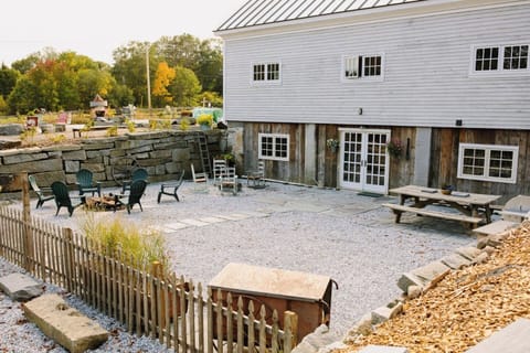 Stone Terrace area with fire pit, picnic table, and gas grill.