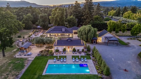 Outdoor Oasis: Stunning poolside retreat surrounded by twinkling lights and lush greenery!