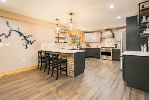 The kitchen is fully equipped and has seats for three at the breakfast bar.