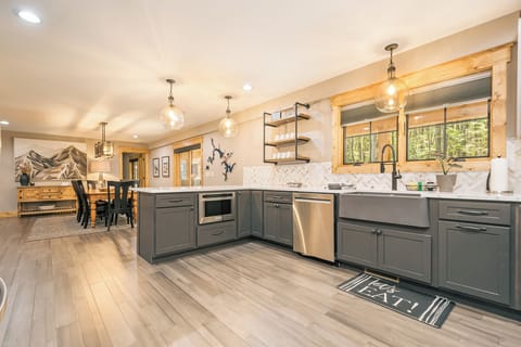 The kitchen has a microwave, dishwasher, and gas stove/oven.