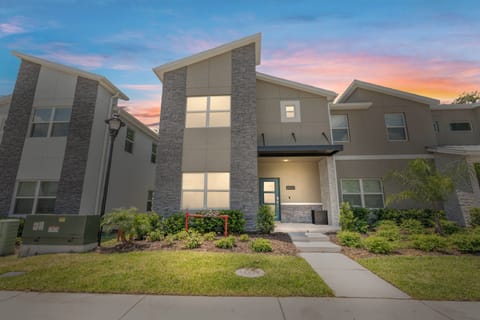 Enter a beautifully designed space with sleek gray stone accents and lush greenery, perfect for relaxation. Large windows invite warm, natural light, creating an uplifting atmosphere for your stay.