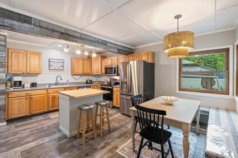 Kitchen with new appliances and ample seating between island and table 