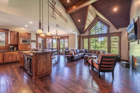 Living Room: Spacious retreat with stunning windows, gourmet kitchen, and inviting seating area!