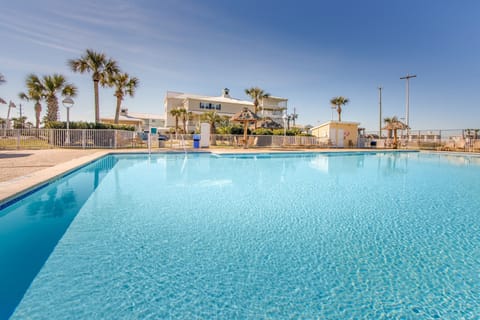 Relax poolside with palm trees swaying softly in the breeze.