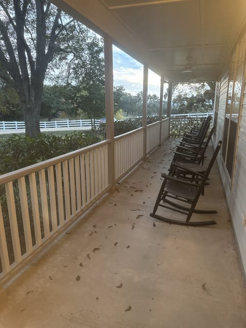 A glass of wine always tastes better in a rocker with a sunset.
