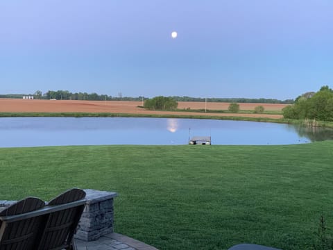 Enjoy sunset views from the front porch. Nothing but the pond and acres of land.