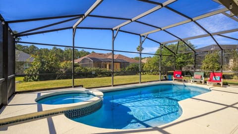 Relax by the screened private pool with scenic backyard views.