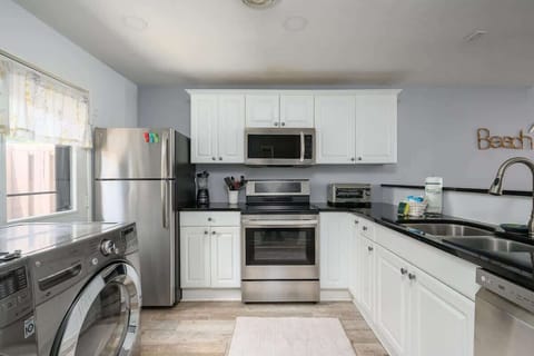 It is fully equipped with stainless steel appliances, including a glass-top range.
