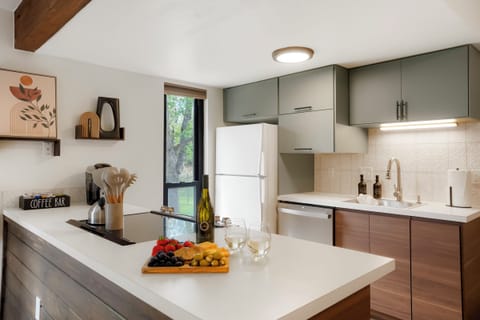 Fully stocked kitchen, with fridge, stove, microwave and dishwasher.