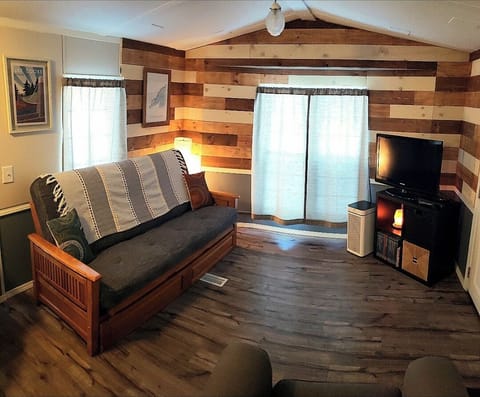 Living area of JC cottage with pull out bed, dvds and atari