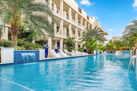 Take a refreshing dip in the communal pool at Wariruri, surrounded by lush greenery and plenty of space to lounge and unwind.