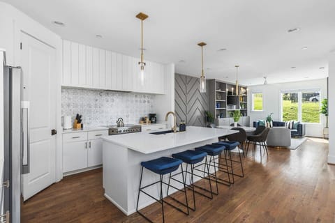 High-end appliances, large pantry, and all the cooking supplies you might need in this bright & fresh kitchen with seating for four at the island.