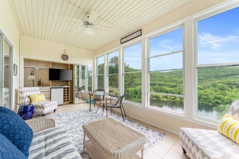 Experience ultimate relaxation in our sunroom, offering breathtaking panoramic views of Lake Taneycomo. Your serene retreat awaits!