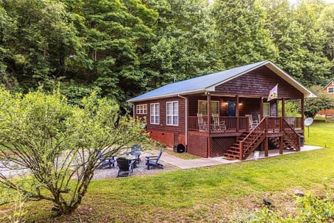 Welcome to Diamond Creek Cabin with a cozy porch and wooded surroundings.
