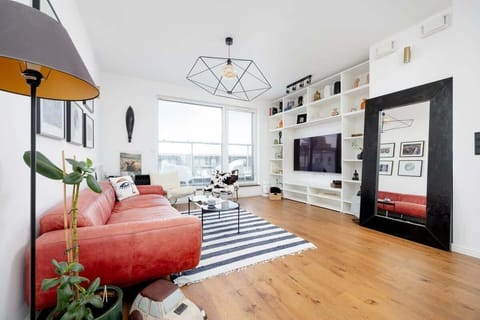 Relax in the stylish living room with a comfortable sofa and modern decor.