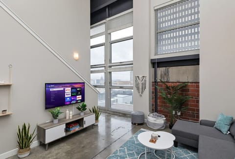 Main living space with sectional sleeper sofa and 50` Smart TV