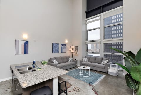Living area with breakfast bar/island, 2 couches and 65` Roku Smart TV